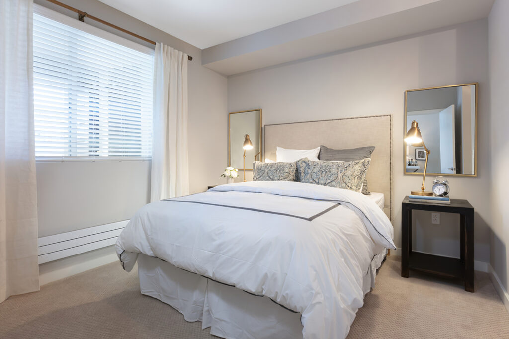 bedroom view with bed, decor, and carpet flooring